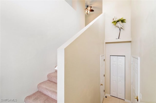 stairway with tile patterned floors