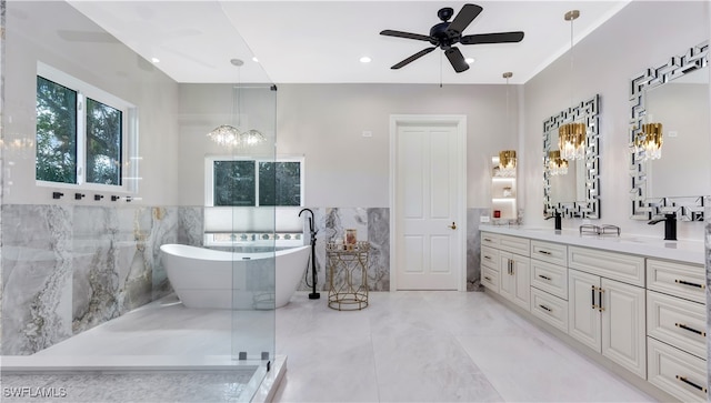 bathroom featuring vanity, shower with separate bathtub, tile walls, and ceiling fan