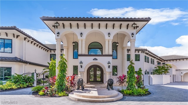 mediterranean / spanish-style house with french doors