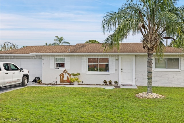 single story home featuring a front yard and a garage