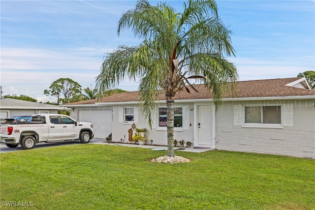 single story home with a garage and a front lawn