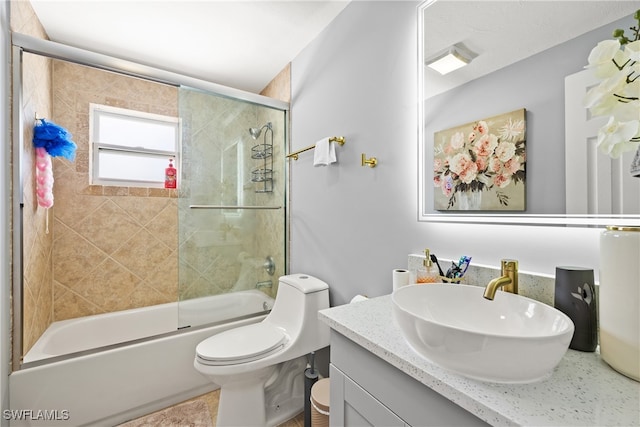 full bathroom with vanity, toilet, and bath / shower combo with glass door