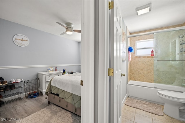 bathroom featuring enclosed tub / shower combo, tile patterned flooring, toilet, and ceiling fan