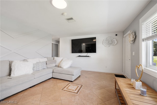 living room with a healthy amount of sunlight and light tile patterned floors