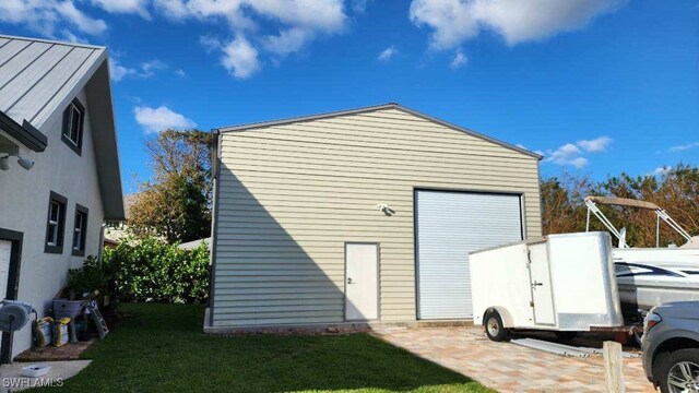 view of outdoor structure featuring a yard and a garage