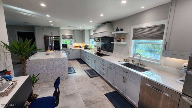 kitchen with gray cabinets, sink, stainless steel fridge with ice dispenser, and custom range hood