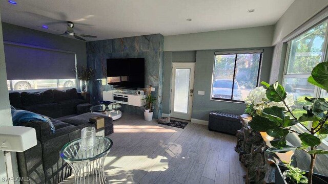 living room with wood-type flooring and ceiling fan