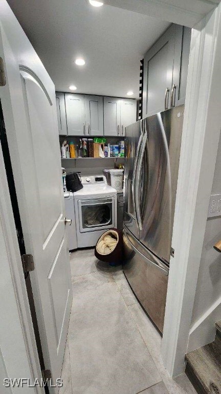 laundry area featuring cabinets and washing machine and clothes dryer