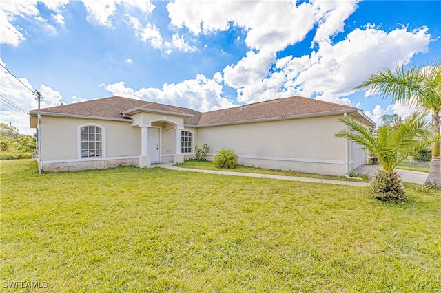 mediterranean / spanish-style house with a front lawn