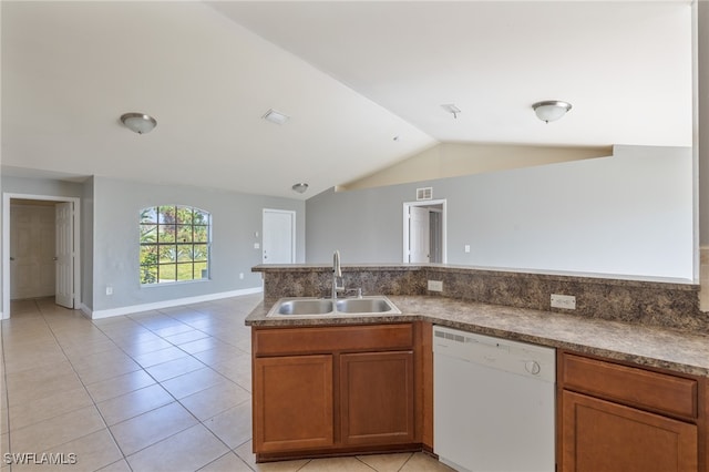 kitchen with sink, dishwasher, vaulted ceiling, and light tile patterned flooring