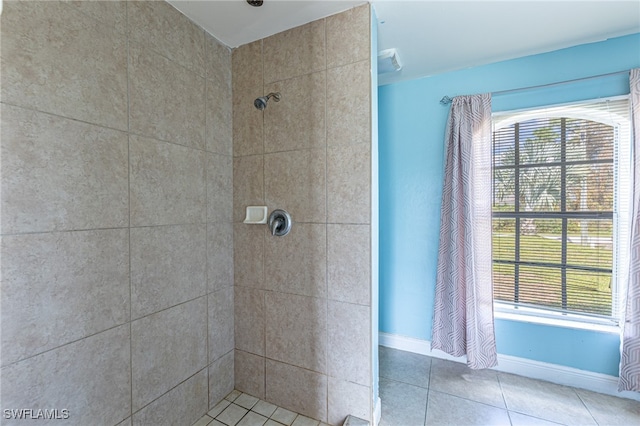 bathroom featuring tile patterned floors and a tile shower