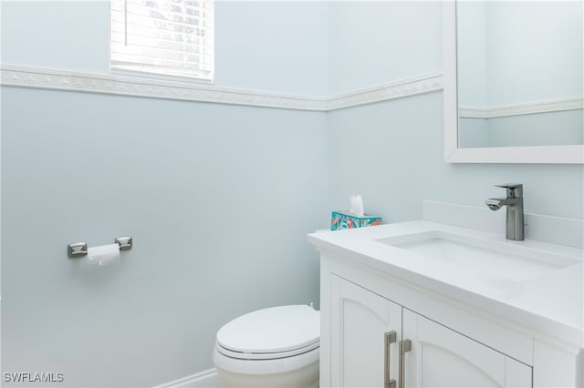 bathroom with vanity and toilet