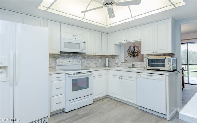 kitchen featuring white cabinets, sink, white appliances, and ceiling fan