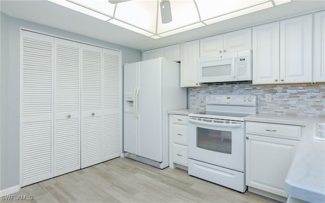 kitchen featuring white cabinets, white appliances, and light hardwood / wood-style floors