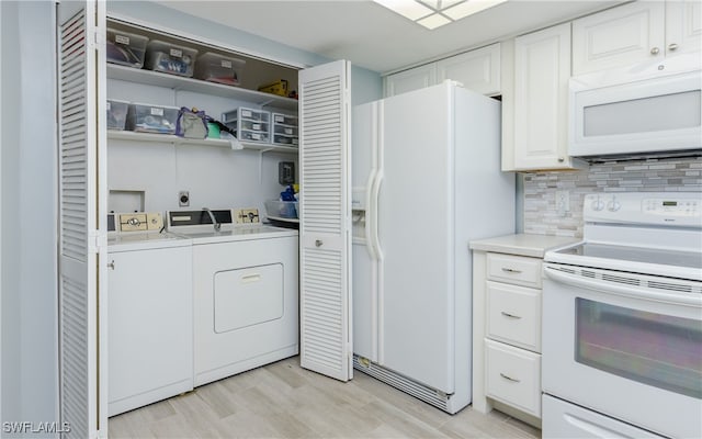 kitchen with decorative backsplash, washing machine and clothes dryer, white cabinetry, light hardwood / wood-style flooring, and white appliances