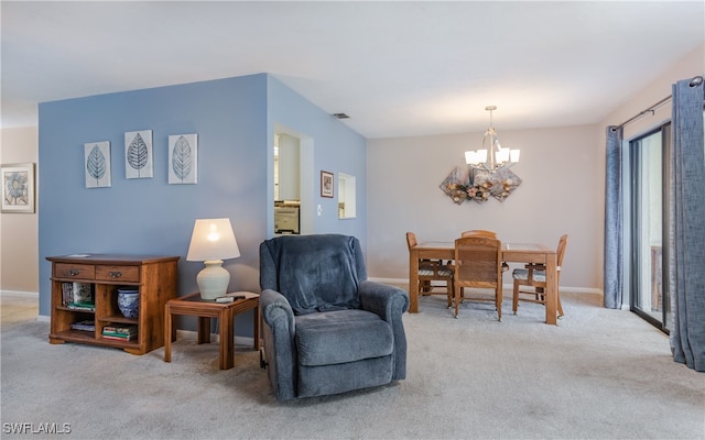 living area with light carpet and a chandelier