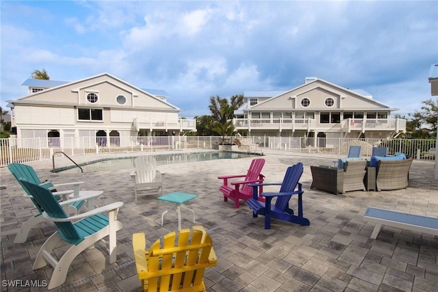 view of pool featuring outdoor lounge area and a patio