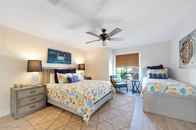 bedroom with light hardwood / wood-style flooring and ceiling fan