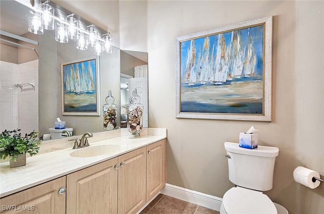 bathroom with tile patterned flooring, vanity, and toilet