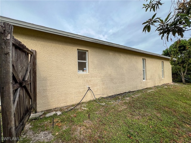 view of side of home featuring a yard