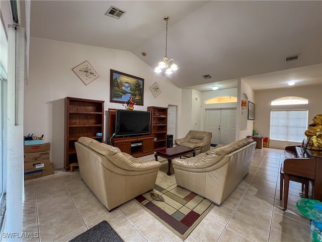 living room featuring lofted ceiling, a chandelier, and light tile patterned floors