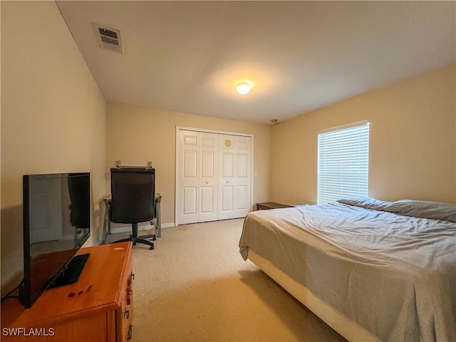 carpeted bedroom with a closet