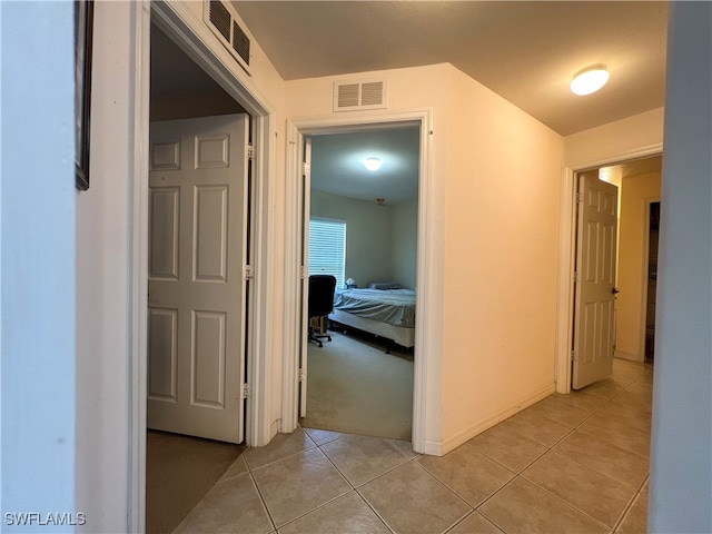 hallway featuring light tile patterned floors