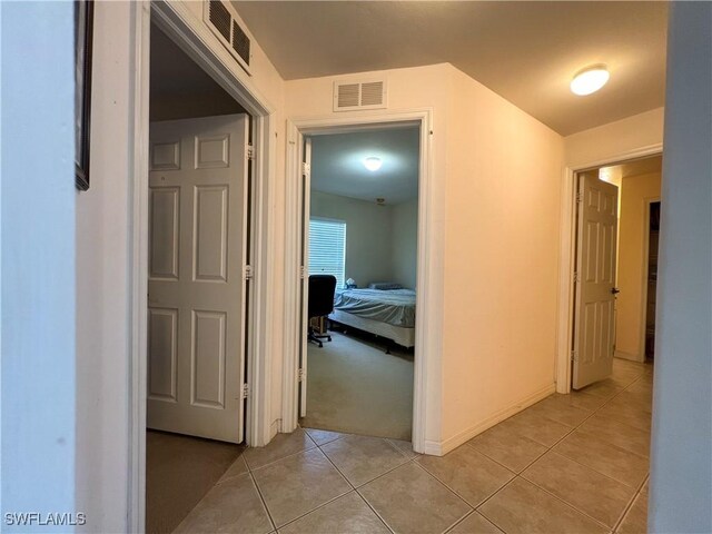 4895 Golfview Blvd, Lehigh Acres, FL 33973 - hall featuring light tile patterned flooring and light colored carpet