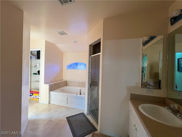 bathroom with vanity, independent shower and bath, vaulted ceiling, and tile patterned flooring