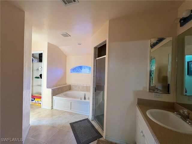 4895 Golfview Blvd, Lehigh Acres, FL 33973 - bathroom with a stall shower, vanity, tile patterned flooring, a bath, and vaulted ceiling