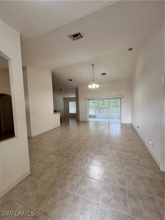 4895 Golfview Blvd, Lehigh Acres, FL 33973 - unfurnished room featuring a chandelier and light tile patterned floors