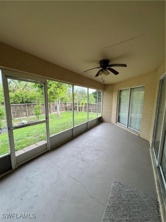 4895 Golfview Blvd, Lehigh Acres, FL 33973 - unfurnished sunroom featuring a ceiling fan