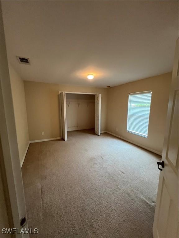 4895 Golfview Blvd, Lehigh Acres, FL 33973 - unfurnished bedroom with carpet flooring