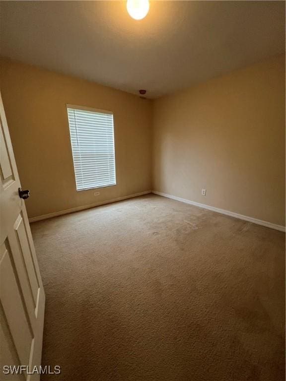 4895 Golfview Blvd, Lehigh Acres, FL 33973 - empty room featuring baseboards and light carpet