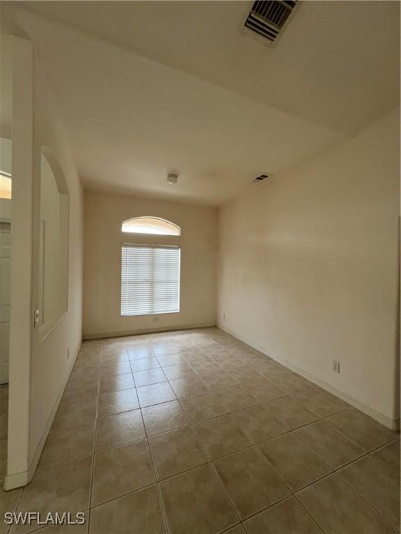 4895 Golfview Blvd, Lehigh Acres, FL 33973 - tiled spare room featuring baseboards