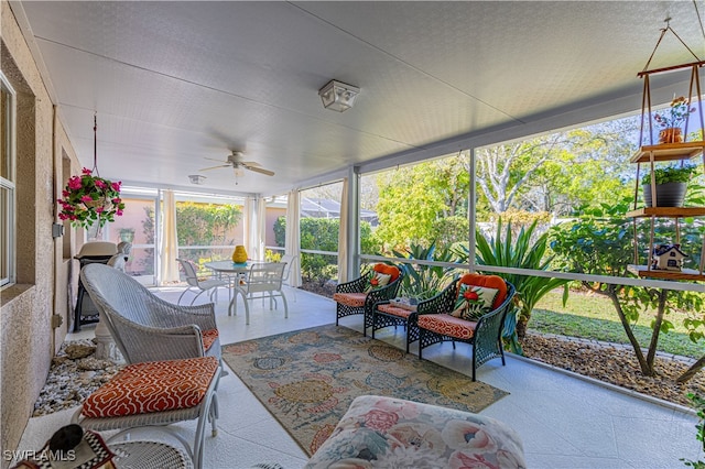 sunroom featuring ceiling fan