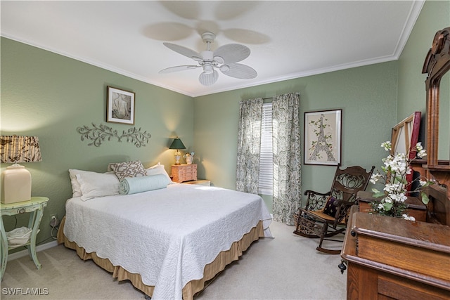 carpeted bedroom featuring ornamental molding and ceiling fan