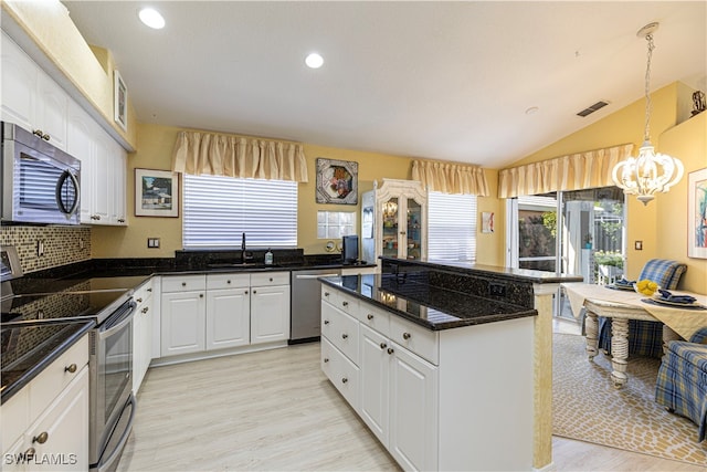 kitchen with sink, white cabinetry, light hardwood / wood-style flooring, a kitchen island, and stainless steel appliances