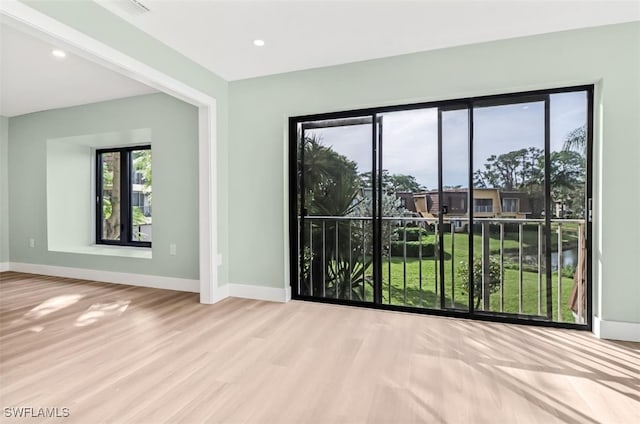 spare room with light hardwood / wood-style flooring