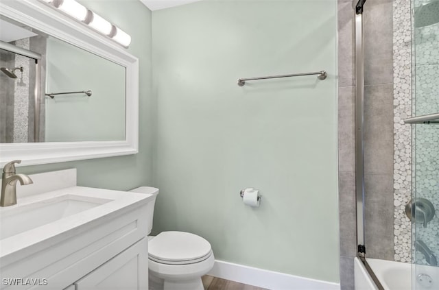 full bathroom with toilet, vanity, bath / shower combo with glass door, and hardwood / wood-style floors