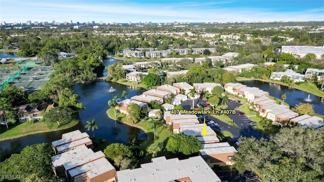 birds eye view of property with a water view