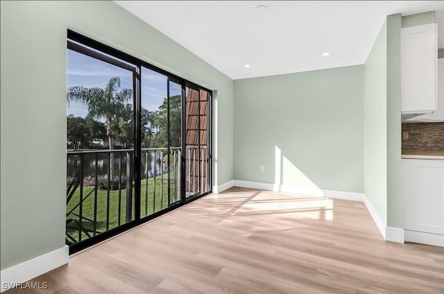 spare room featuring light hardwood / wood-style floors