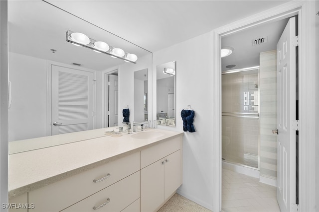 bathroom featuring vanity, tile patterned floors, and an enclosed shower