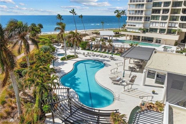 view of pool with a water view and a patio area