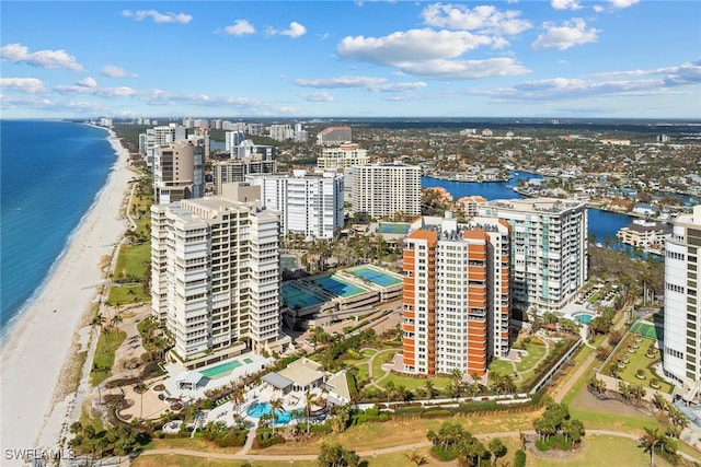 birds eye view of property with a water view and a view of the beach