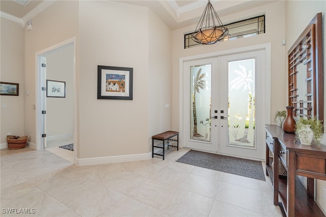 entryway featuring ornamental molding, french doors, and baseboards