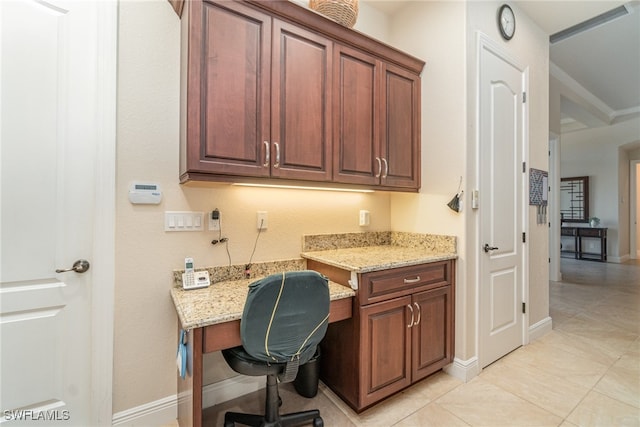 office with light tile patterned flooring, built in desk, and baseboards