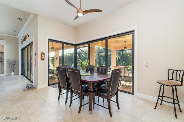 dining space with visible vents, baseboards, a ceiling fan, and ornamental molding