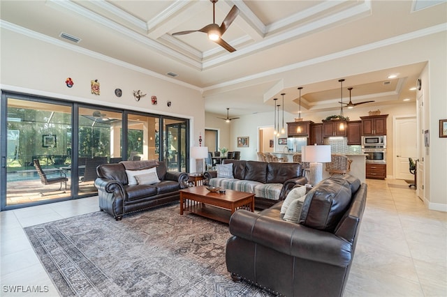 living area featuring ceiling fan, ornamental molding, coffered ceiling, and a tray ceiling