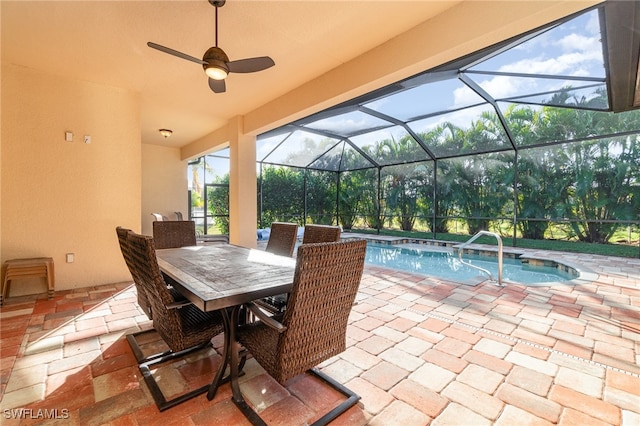 view of patio / terrace with an outdoor pool, glass enclosure, and ceiling fan